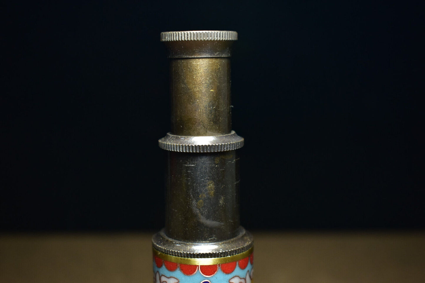 An ancient brass based cloisonne telescope