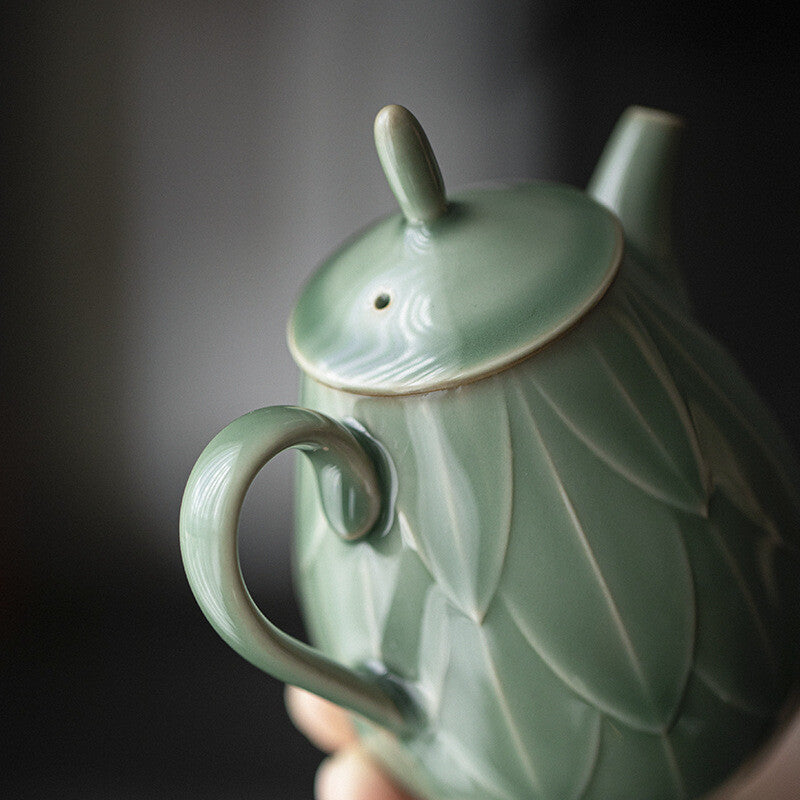 180ml Yue kiln porcelain tea pot with ball shaped infuser holes lotus relief pot
